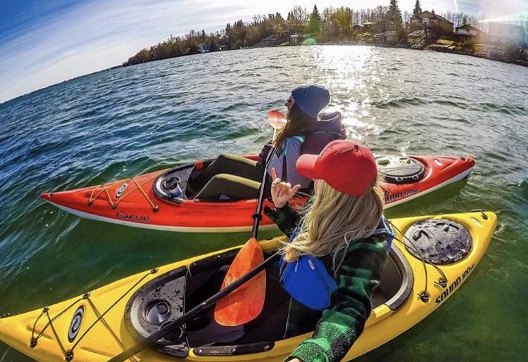 Campfire Collective Ambassador Leah Tyler-Szucki and friend taking a selfie while in their kayaks.